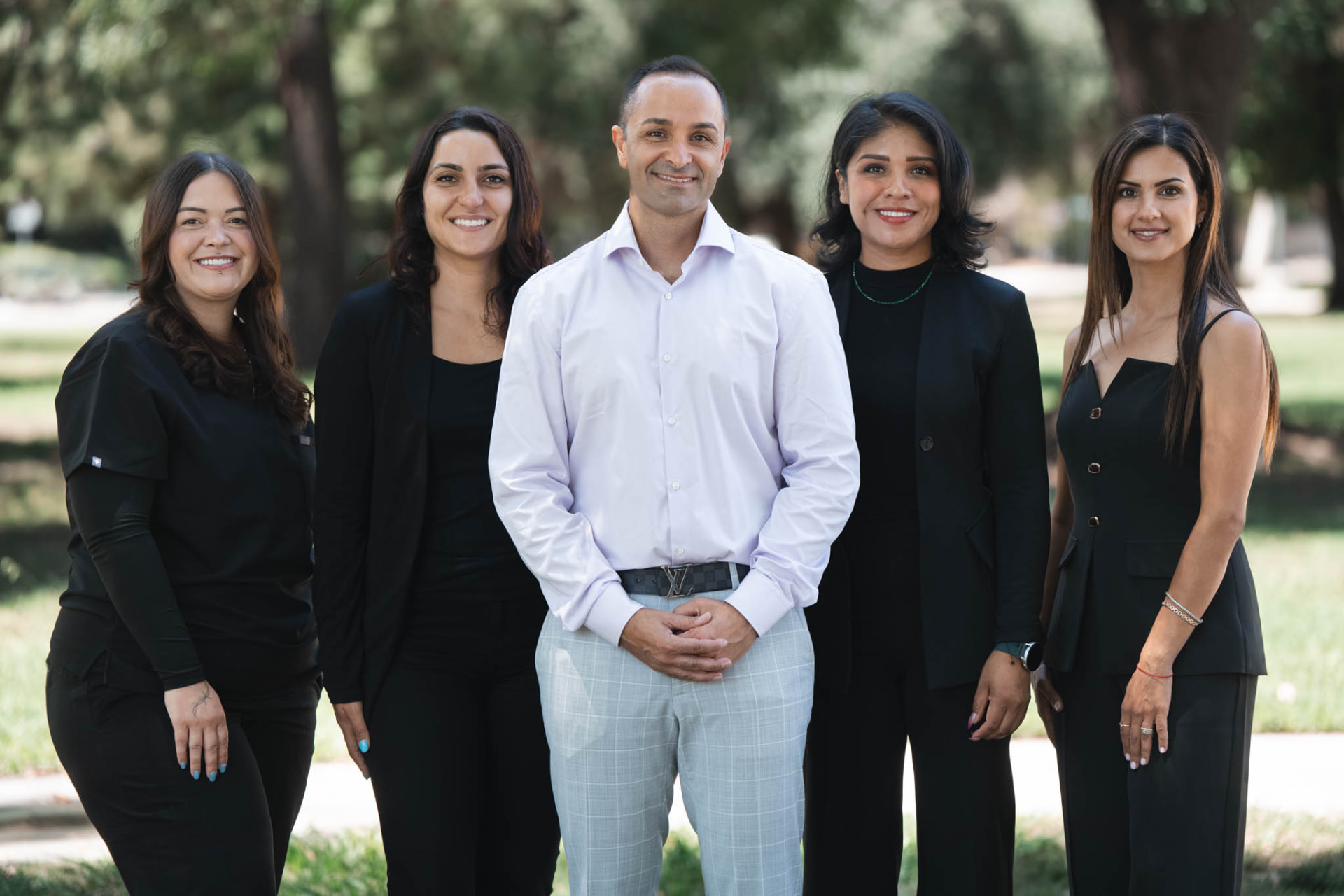The Smiles by Eddie team standing together outdoors in Woodland Hills