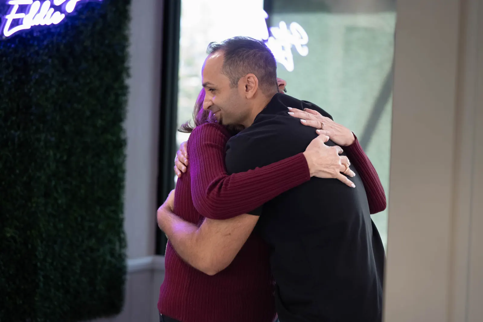 Dr. Edmond Ahdoot sharing a hug with a patient at Smiles by Eddie